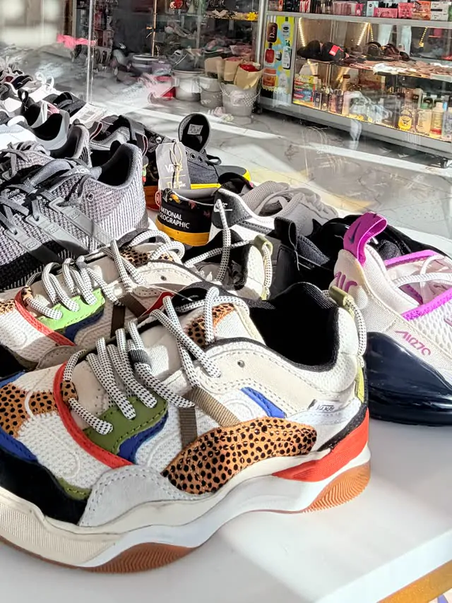 Colorful children's sneakers lined up on the shoe table